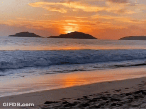 A Sunset Over A Beach With A Few Islands In The Distance GIF