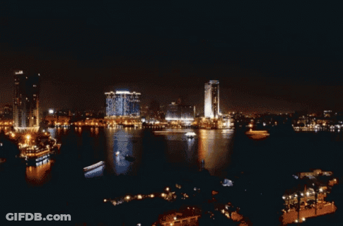 A Sunset Over A Body Of Water With A Building That Says ' Huawei ' On It GIF