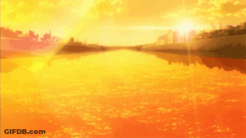 A Sunset Over A Body Of Water With A City In The Distance GIF