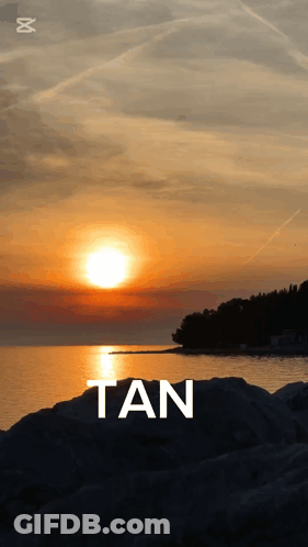 A Sunset Over A Body Of Water With The Word Tan GIF