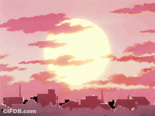 A Sunset Over A City With A Large Sun Shining Through The Clouds GIF