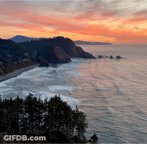 A Sunset Over The Ocean With A Cliff In The Background GIF