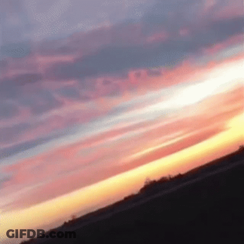 A Sunset With A Few Clouds In It GIF
