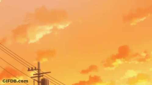A Sunset With Power Lines In The Foreground And Orange Clouds In The Background GIF