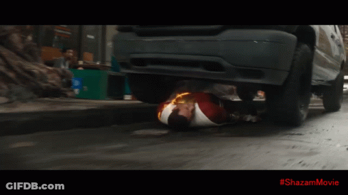 A Superhero Is Laying On The Ground With A #Shazammovie Written On The Bottom GIF