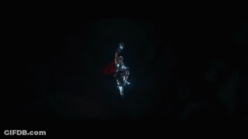 A Superhero With A Red Cape Is Being Struck By Lightning GIF