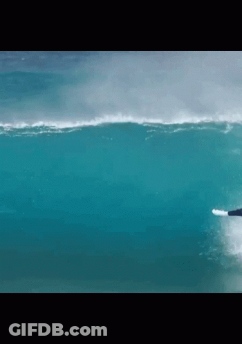 A Surfer Is Riding A Wave In The Ocean GIF