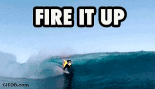 A Surfer Is Riding A Wave With The Words Fire It Up Above Him GIF