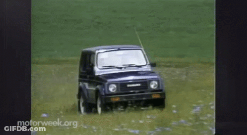 A Suzuki Suv Is Driving Through A Field Of Water GIF