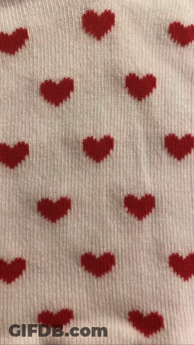 A Sweater With Red Hearts On It GIF