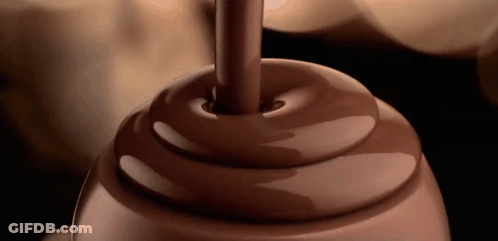 A Swirl Of Chocolate Is Being Poured Into A Container GIF