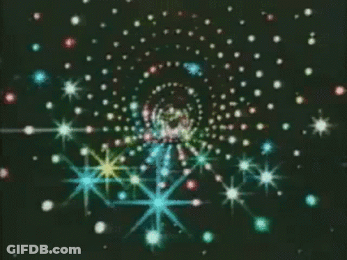 A Swirl Of Multicolored Stars On A Black Background GIF
