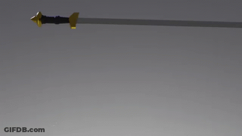 A Sword With A Gold Handle Is Laying On A Gray Surface GIF