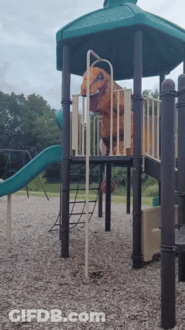 A T-Rex Costume Is On A Playground Set GIF