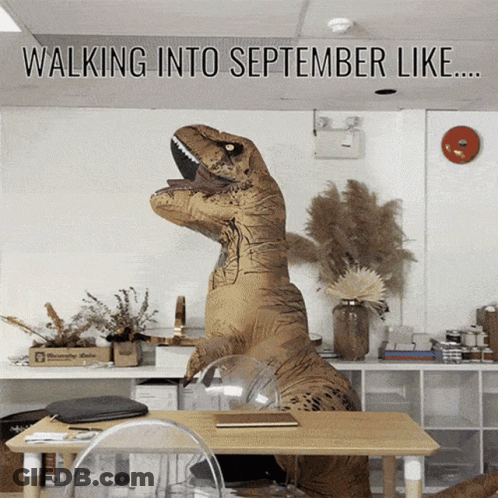 A T-Rex In An Office With The Words Walking Into September Like GIF