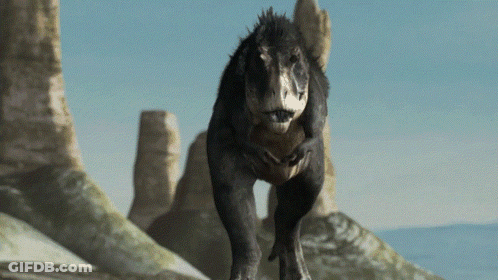 A T-Rex Is Walking Across A Rocky Landscape GIF