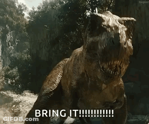 A T-Rex Says " Bring It " In Front Of A Cliff GIF