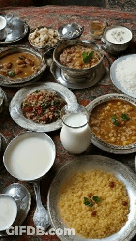 A Table Topped With A Variety Of Food Including Rice And Milk GIF