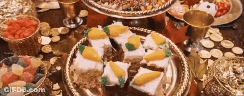 A Table Topped With Plates Of Food And A Bowl Of Fruit . GIF