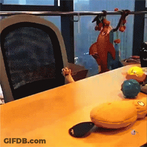 A Table With A Bunch Of Toys On It And A Chair GIF