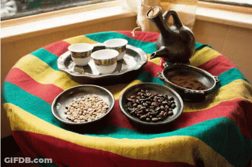 A Table With Bowls Of Coffee Beans And Cups Of Coffee GIF