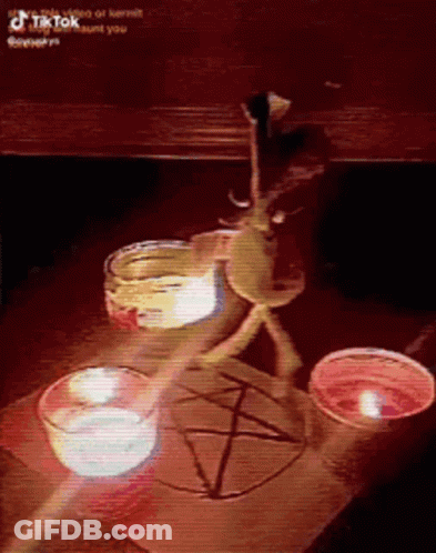 A Table With Candles And A Pentagram Drawn On It . GIF