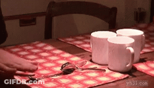A Table With Three Cups And Spoons On It GIF