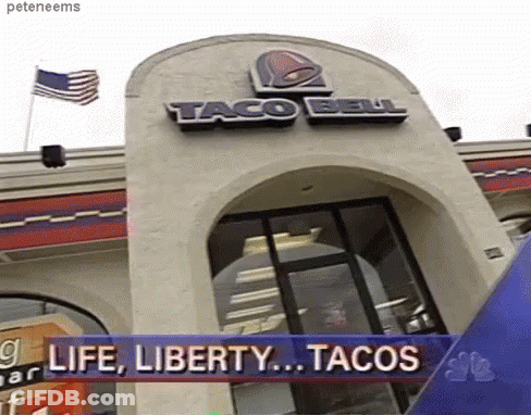 A Taco Bell Restaurant With A Banner That Says " Life Liberty Tacos " GIF