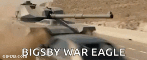 A Tank Is Driving Down A Desert Road Next To A Car With The Words `` Bigsby War Eagle '' Written On It . GIF