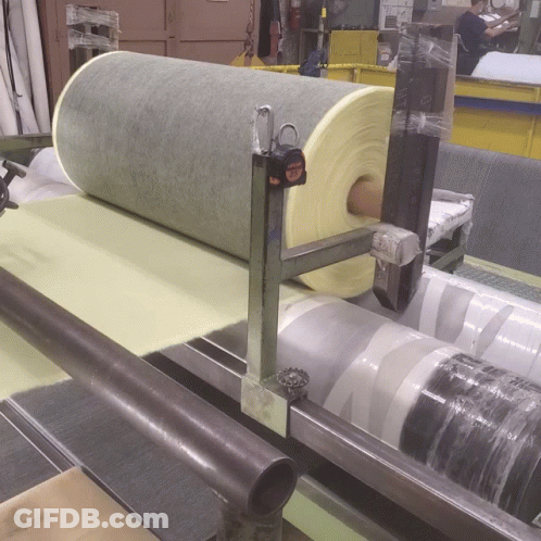 A Tape Measure Sits On Top Of A Roll Of Foam GIF