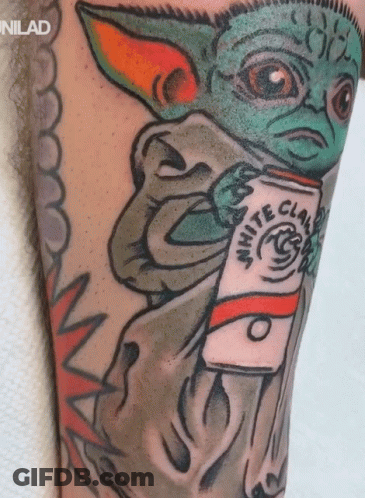 A Tattoo Of A Baby Yoda Holding A White Claw Coffee GIF