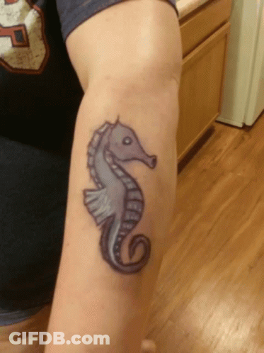 A Tattoo Of A Seahorse On A Person 'S Arm GIF