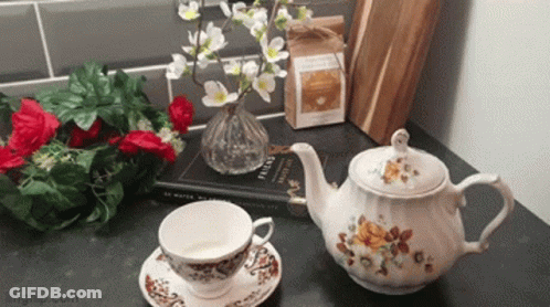 A Teapot Sits On A Table Next To A Cup And Saucer And A Book Titled English GIF