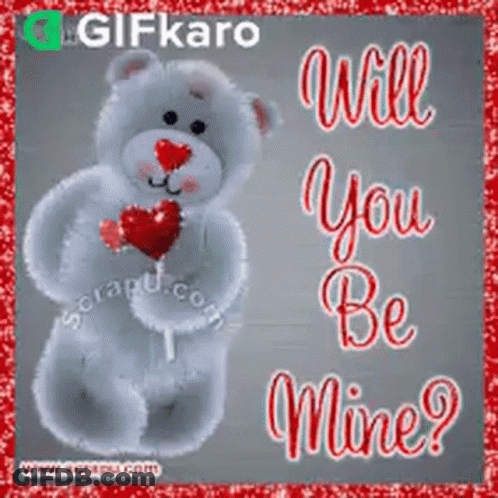 A Teddy Bear Holding A Heart Shaped Lollipop With The Words `` Will You Be Mine '' Written On It . GIF