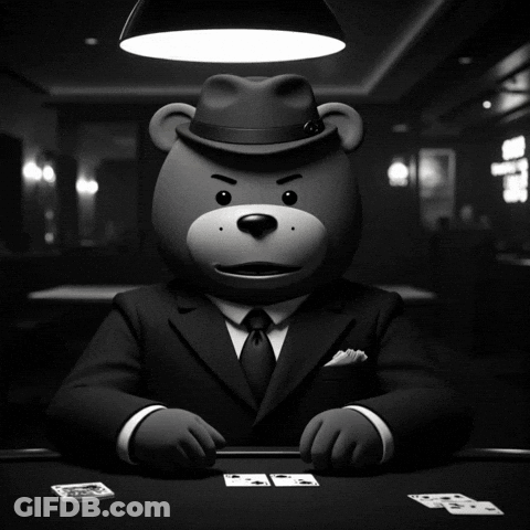 A Teddy Bear In A Suit And Fedora Holding A Bunch Of Cards GIF
