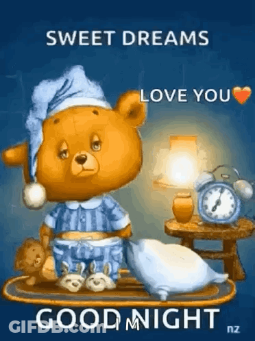 A Teddy Bear In Pajamas Is Sitting On A Tray With A Pillow And A Lamp . GIF