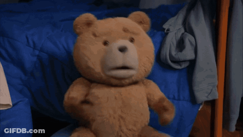 A Teddy Bear Is Dancing On A Rug In A Room . GIF