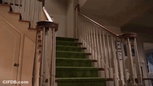A Teddy Bear Is Falling Down A Set Of Green Stairs GIF