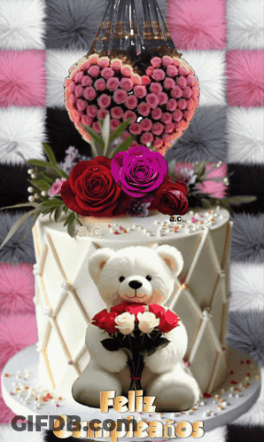 A Teddy Bear Is Holding A Bouquet Of Roses In Front Of A Cake That Says " Feliz Cumpleanos " GIF