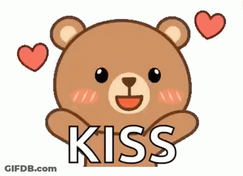 A Teddy Bear Is Holding A Heart And Saying Kiss . GIF
