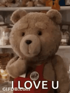 A Teddy Bear Is Holding A Red Heart And Saying `` I Love You '' . GIF