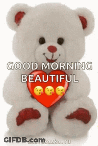 A Teddy Bear Is Holding A Red Heart With Smiley Faces On It And Saying `` Good Morning Beautiful '' . GIF