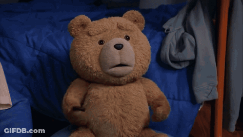 A Teddy Bear Is Running On A Rug In A Bedroom . GIF
