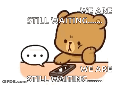 A Teddy Bear Is Sitting At A Table With A Cell Phone And A Speech Bubble Saying We Are Still Waiting .. GIF