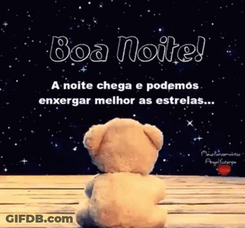 A Teddy Bear Is Sitting On A Wooden Table In Front Of A Starry Sky . GIF