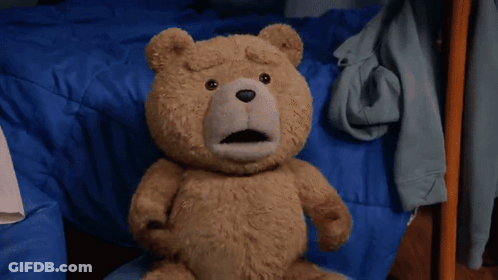 A Teddy Bear Is Standing On A Rug In A Room . GIF