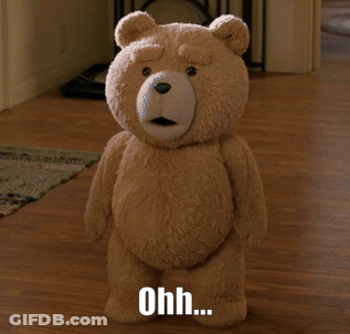 A Teddy Bear Is Standing On A Wooden Floor With The Words Ohh Written Below It GIF