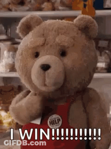 A Teddy Bear Is Wearing A Red Apron And Saying `` I Win !!! '' . GIF
