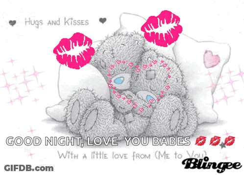 A Teddy Bear Laying On A Pillow With Hugs And Kisses GIF