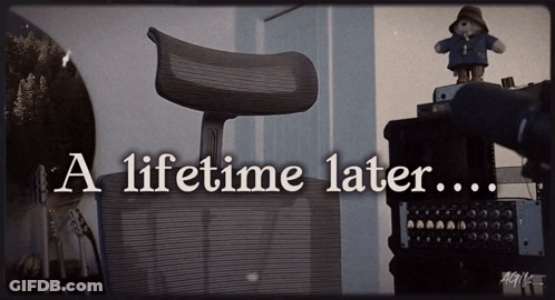 A Teddy Bear Sits On Top Of A Desk With The Words A Lifetime Later GIF
